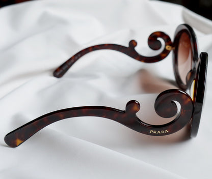 Prada Women Baroque Swirl Round Sunglasses in Havana Brown