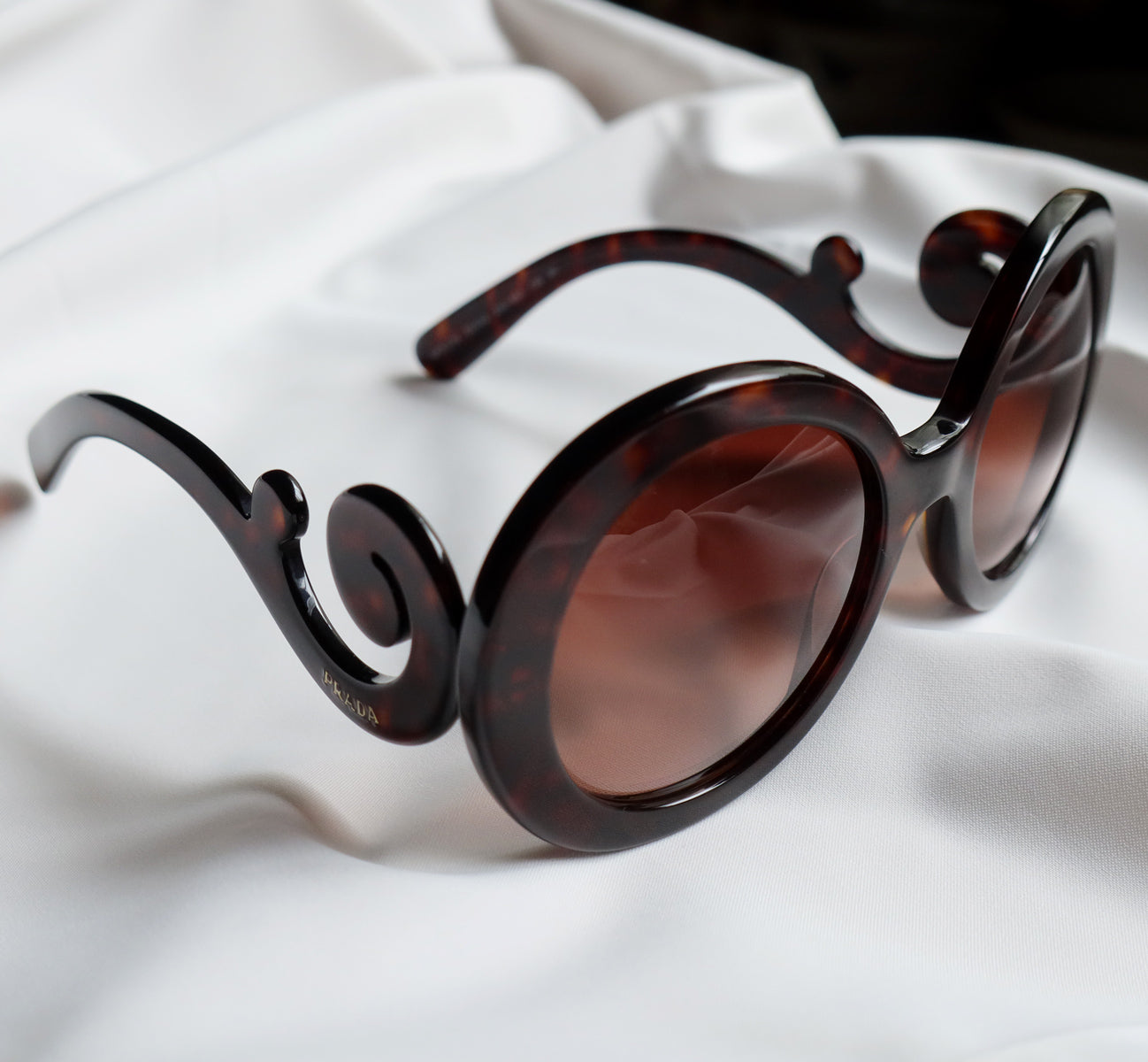 Prada Women Baroque Swirl Round Sunglasses in Havana Brown The Tanpopo Room